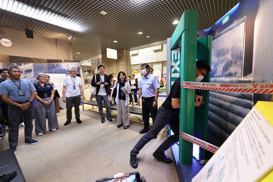 Participants test how heavy a door becomes with 30 centimeters of standing water at their feet.